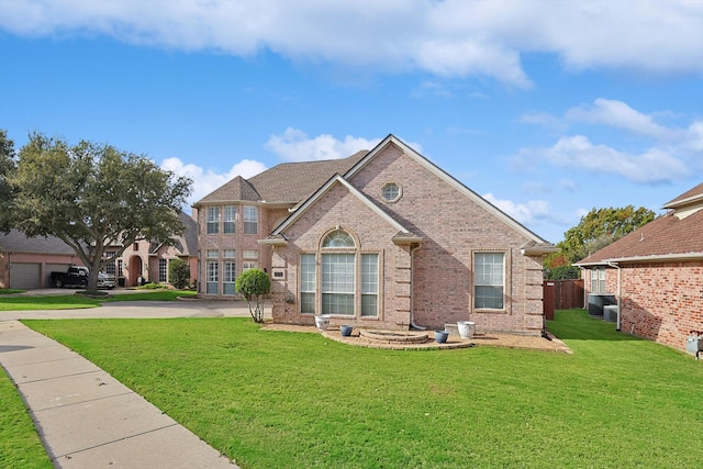 view of front facade with central AC unit and a front yard