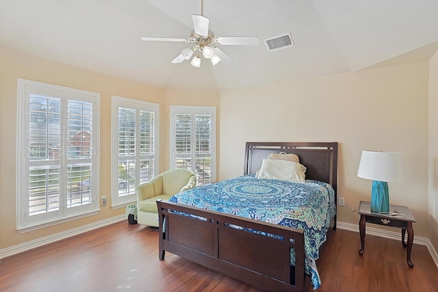 bedroom with hardwood / wood-style floors, multiple windows, and ceiling fan