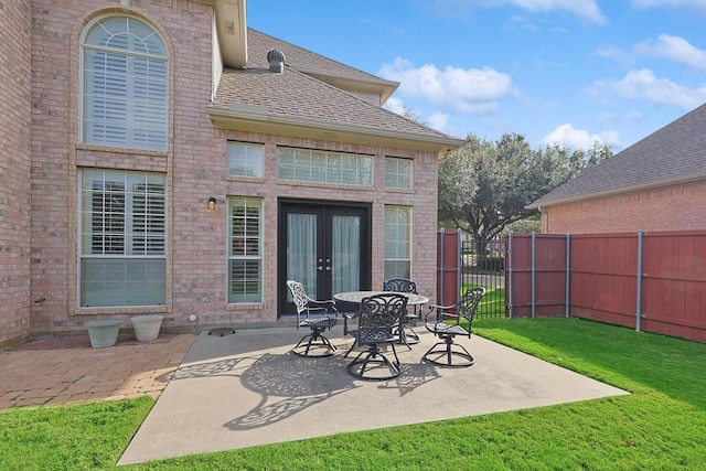 rear view of property with a yard, a patio area, and french doors