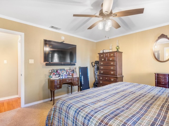 carpeted bedroom with ceiling fan and crown molding