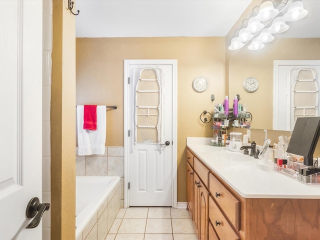 bathroom featuring tile patterned floors, vanity, and tiled bath