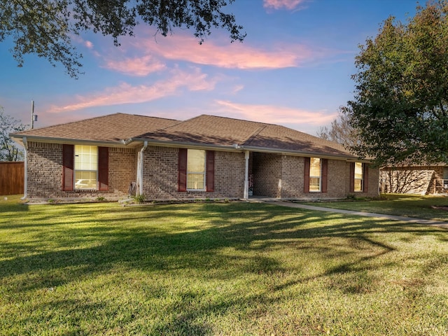 single story home with a lawn