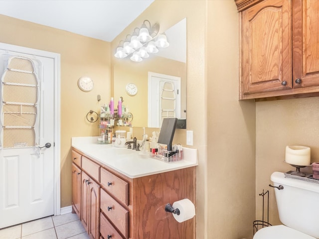 bathroom featuring toilet, vanity, and tile patterned floors