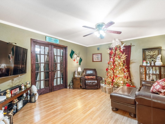 living room with french doors, light hardwood / wood-style floors, ceiling fan, and ornamental molding