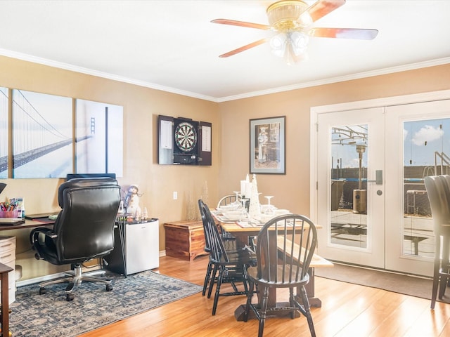 office with crown molding, french doors, ceiling fan, and light wood-type flooring