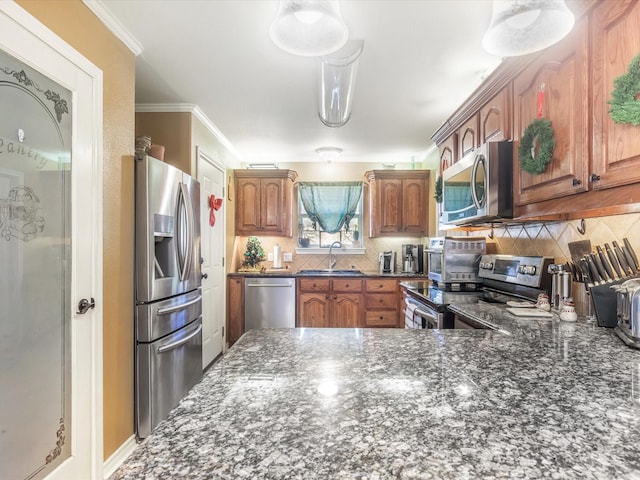 kitchen with sink, stainless steel appliances, backsplash, pendant lighting, and ornamental molding