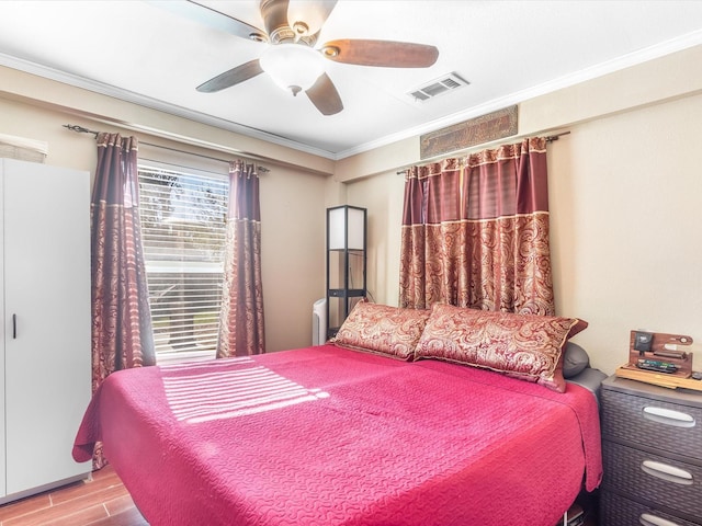 bedroom featuring ceiling fan, light hardwood / wood-style floors, and ornamental molding