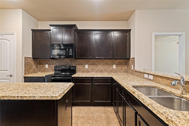 kitchen with light stone countertops, backsplash, sink, black appliances, and light tile patterned floors