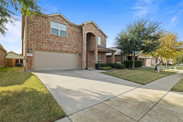 front facade featuring a front lawn and a garage