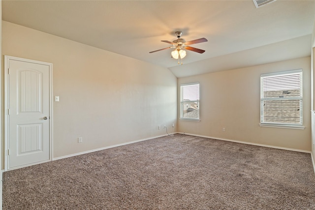 carpeted empty room featuring ceiling fan and vaulted ceiling