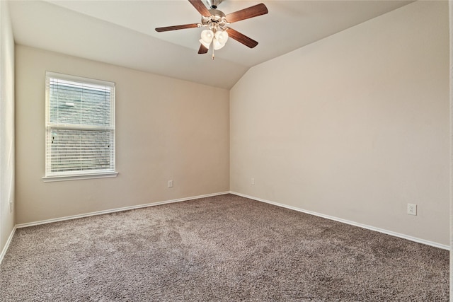 carpeted empty room with vaulted ceiling and ceiling fan