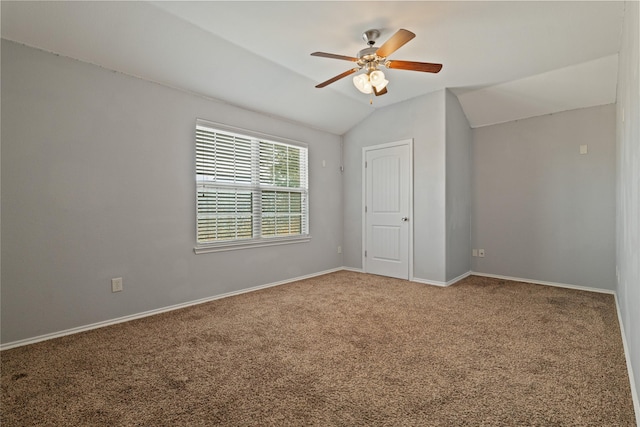 carpeted empty room with ceiling fan and lofted ceiling