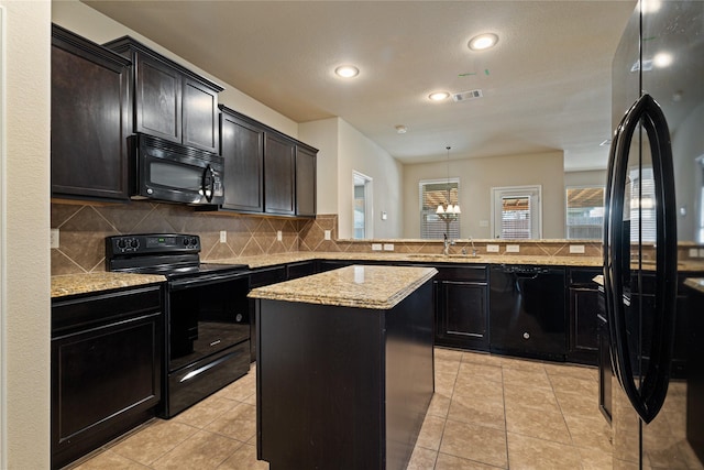 kitchen featuring tasteful backsplash, kitchen peninsula, pendant lighting, a kitchen island, and black appliances