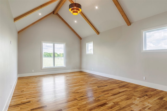 spare room featuring beam ceiling, high vaulted ceiling, and light hardwood / wood-style flooring