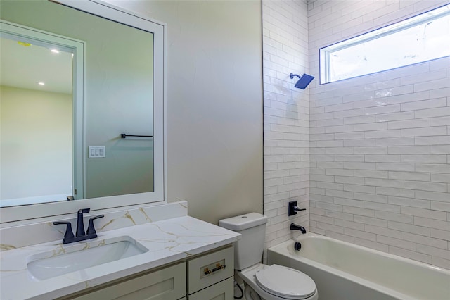 full bathroom featuring tiled shower / bath combo, toilet, and vanity