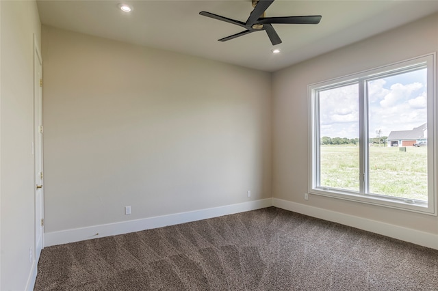 carpeted empty room with plenty of natural light and ceiling fan