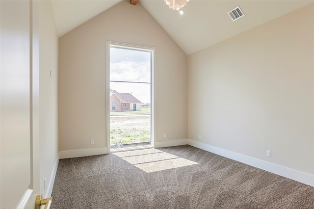 carpeted empty room with lofted ceiling