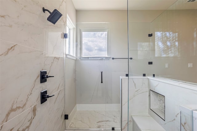 bathroom featuring a shower with door