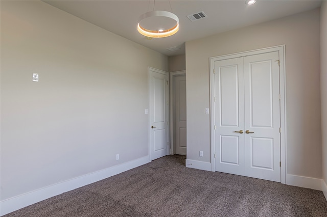 unfurnished bedroom with carpet floors and a closet