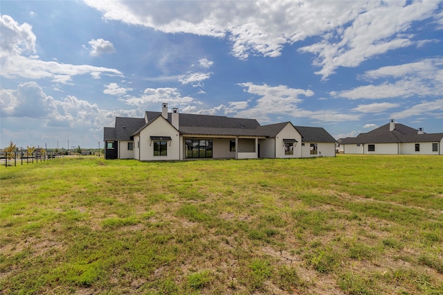 back of property featuring a yard