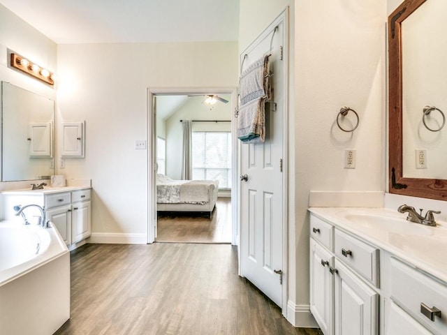 bathroom featuring vanity, hardwood / wood-style floors, and a bathtub