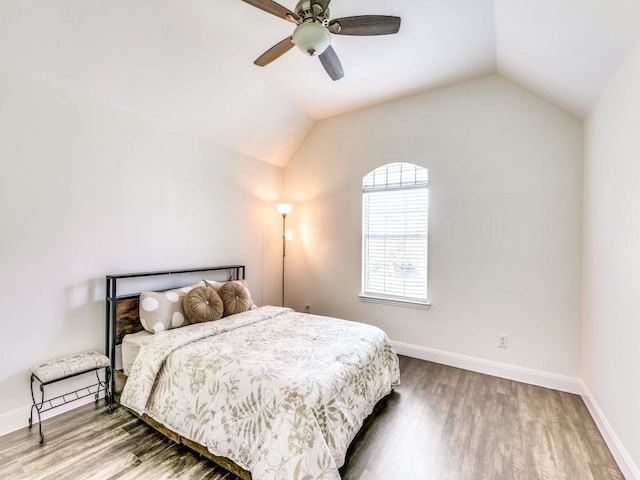 bedroom featuring hardwood / wood-style flooring, vaulted ceiling, and ceiling fan