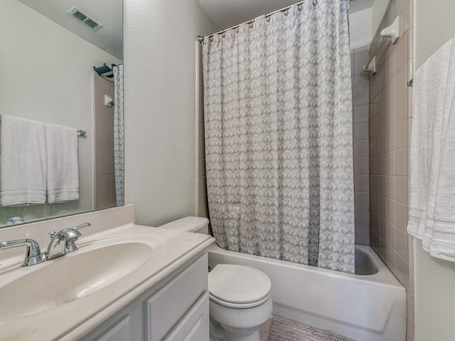 full bathroom featuring vanity, shower / bath combination with curtain, and toilet