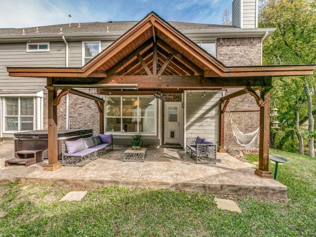 back of property with a hot tub and a patio