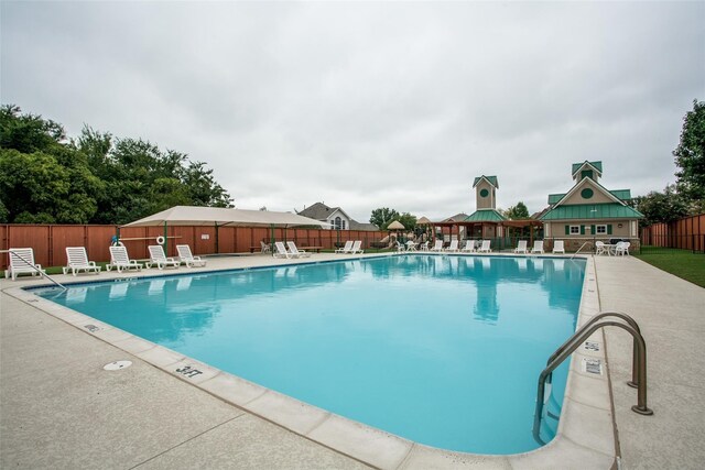 view of swimming pool featuring a gazebo and a patio