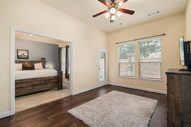 bedroom with ceiling fan and dark wood-type flooring