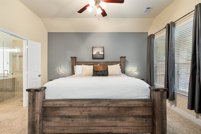 carpeted bedroom with lofted ceiling, ensuite bath, and ceiling fan