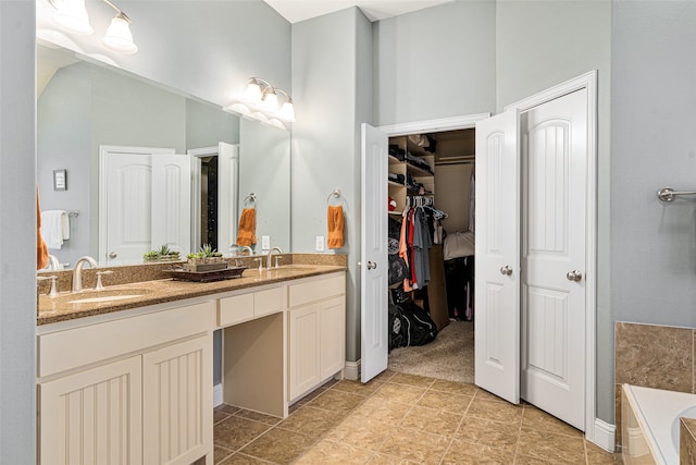 bathroom with vanity and a washtub