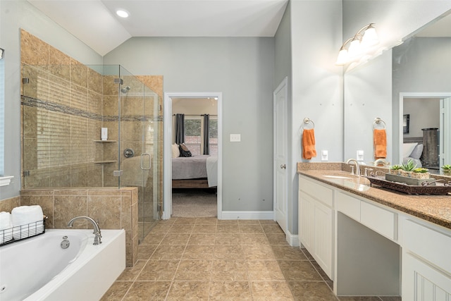 bathroom with independent shower and bath, vaulted ceiling, and vanity