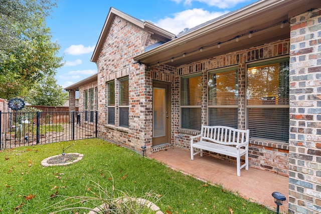 view of side of property with a yard and a patio