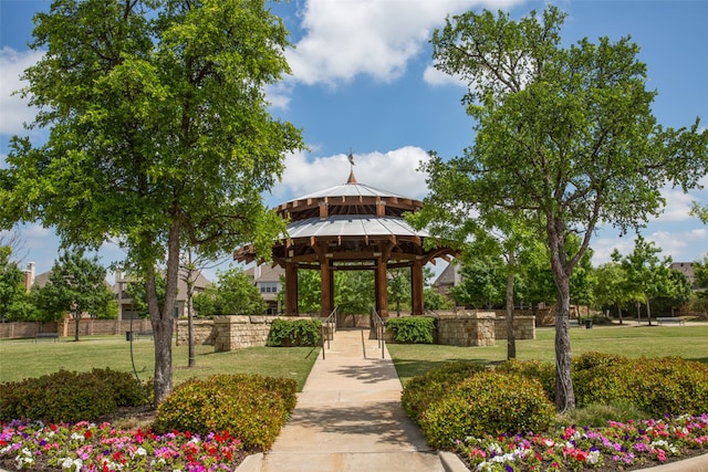 view of home's community with a lawn and a gazebo