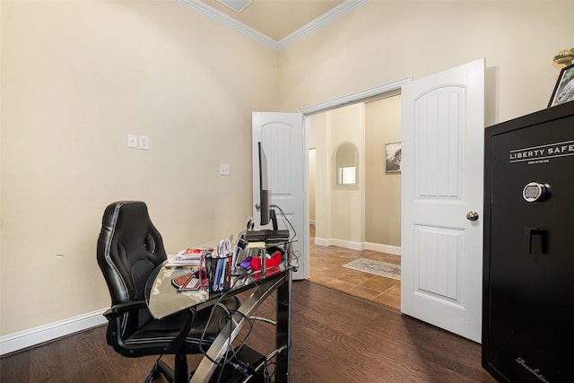 home office featuring dark wood-type flooring and crown molding