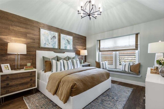 bedroom with dark hardwood / wood-style floors, wooden walls, and an inviting chandelier