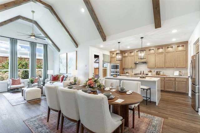 dining area featuring dark hardwood / wood-style floors, high vaulted ceiling, beamed ceiling, sink, and ceiling fan