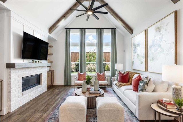 living room with dark wood-type flooring, ceiling fan, a brick fireplace, and vaulted ceiling with beams