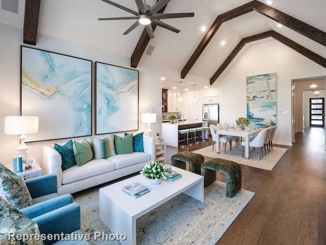 living room with ceiling fan with notable chandelier, beam ceiling, dark hardwood / wood-style flooring, and high vaulted ceiling