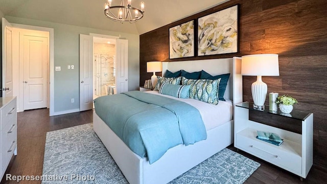 bedroom with vaulted ceiling, connected bathroom, wood walls, a notable chandelier, and dark wood-type flooring