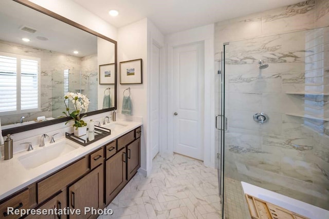 bathroom with vanity and a shower with door