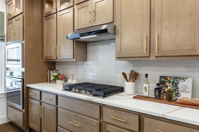 kitchen with tasteful backsplash and appliances with stainless steel finishes