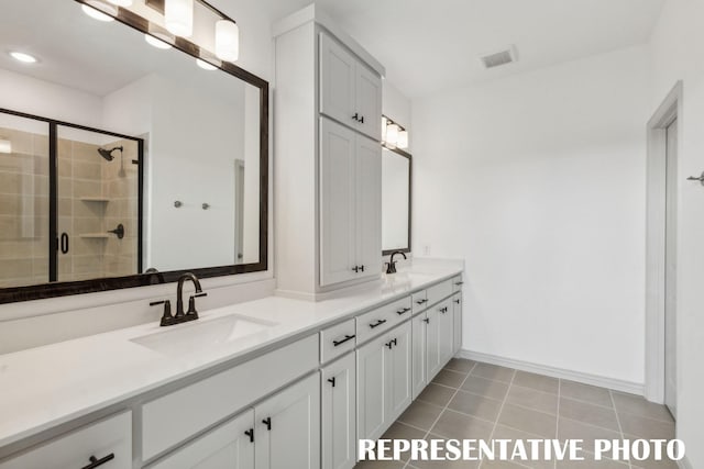 bathroom with tile patterned flooring, vanity, and an enclosed shower