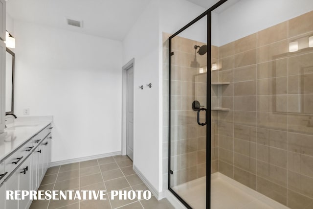 bathroom with vanity, tile patterned floors, and a shower with door