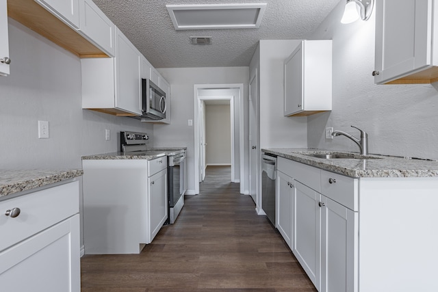 kitchen featuring sink, white cabinets, stainless steel appliances, and dark hardwood / wood-style floors