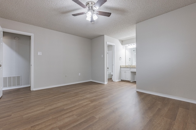 interior space with hardwood / wood-style flooring, ceiling fan, and a textured ceiling