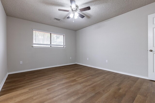 empty room with ceiling fan, a textured ceiling, and hardwood / wood-style flooring