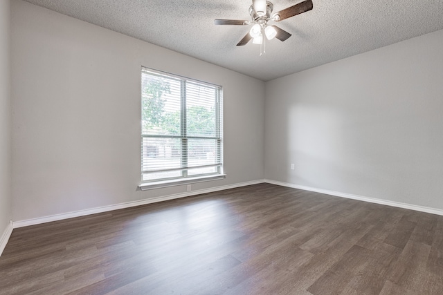 spare room with ceiling fan, dark hardwood / wood-style flooring, and a textured ceiling