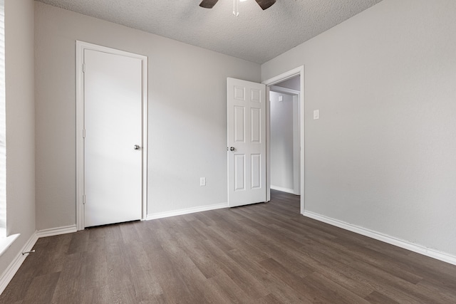 unfurnished bedroom featuring a textured ceiling, ceiling fan, and dark hardwood / wood-style floors